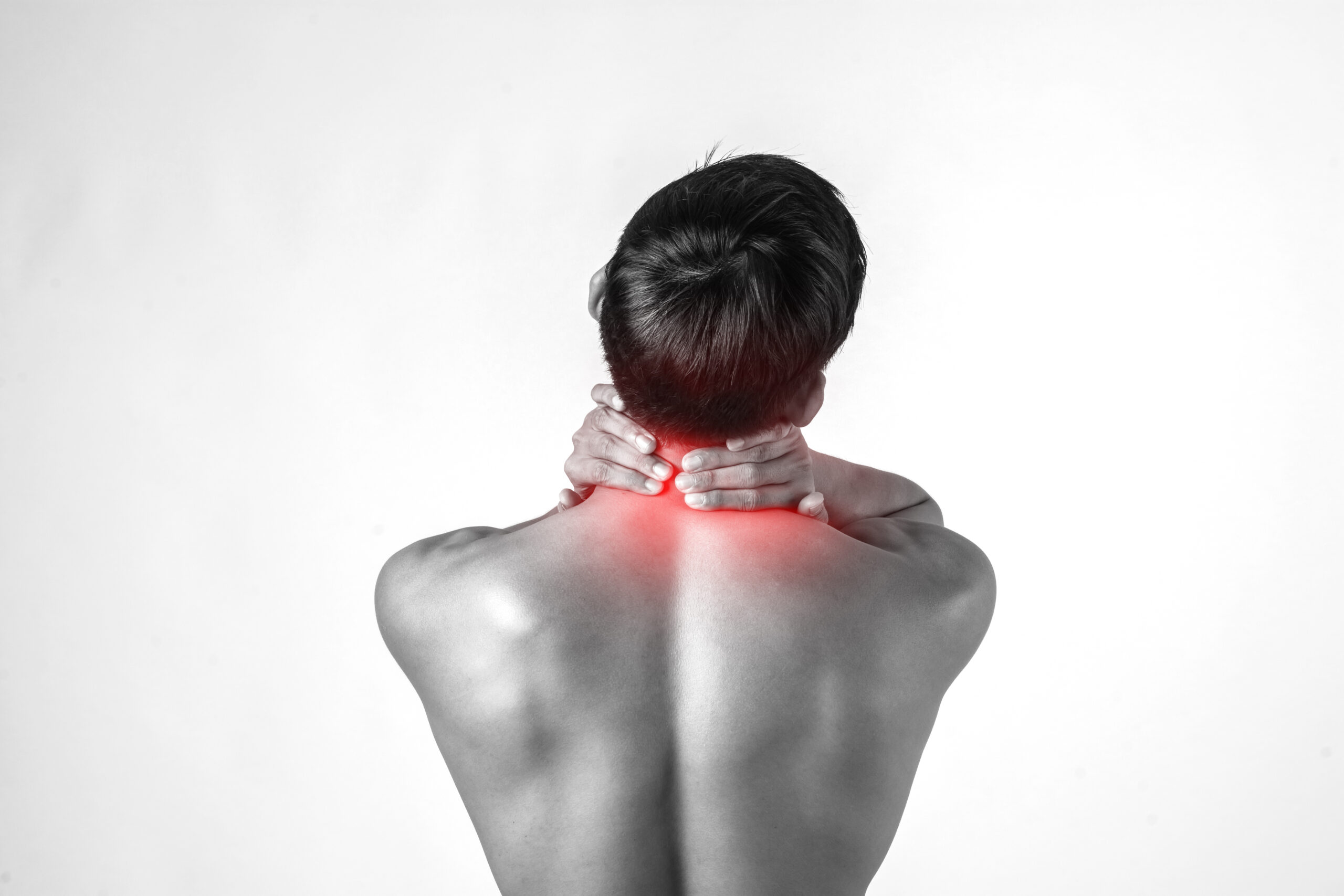 Muscular man use handles at the neck to relieve pain isolated on white background.